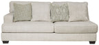 Parchment beige upholstered sofa with two seat cushions and decorative pillows