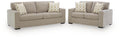Living room set: light beige sofa and loveseat with patterned throw pillows