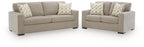 Living room set: light beige sofa and loveseat with patterned throw pillows
