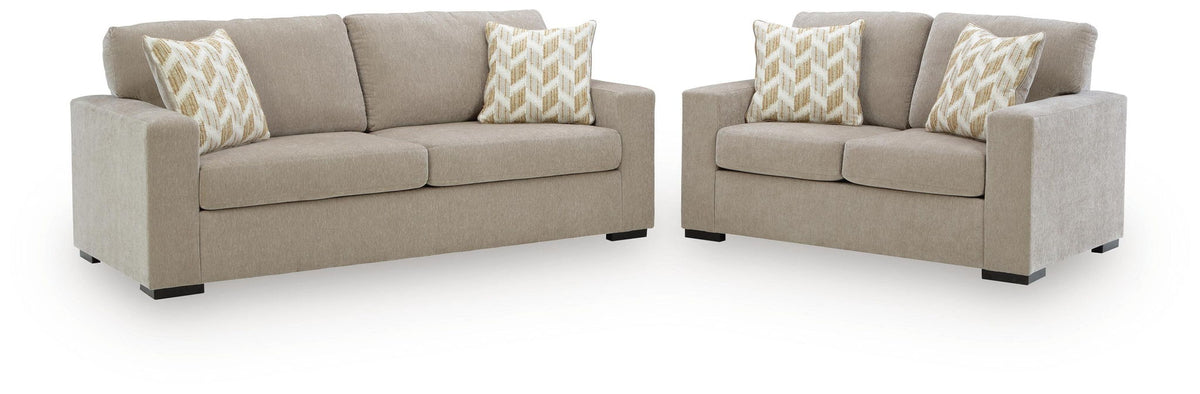Living room set: light beige sofa and loveseat with patterned throw pillows