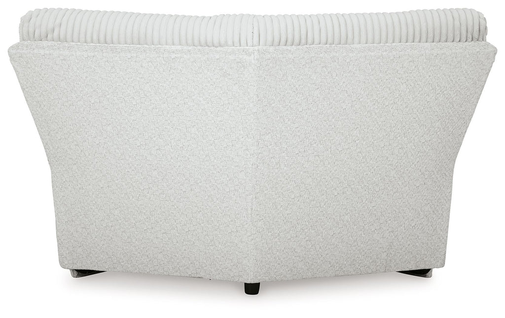 Light gray ribbed wedge sectional sofa with curved back and black legs