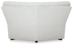Light gray ribbed wedge sectional sofa with curved back and black legs
