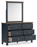 Dark blue dresser with mirror, brown top, six drawers with one open drawer