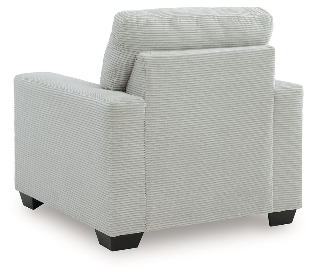 Upholstered armchair with striped texture, rounded back, and block legs in light gray.