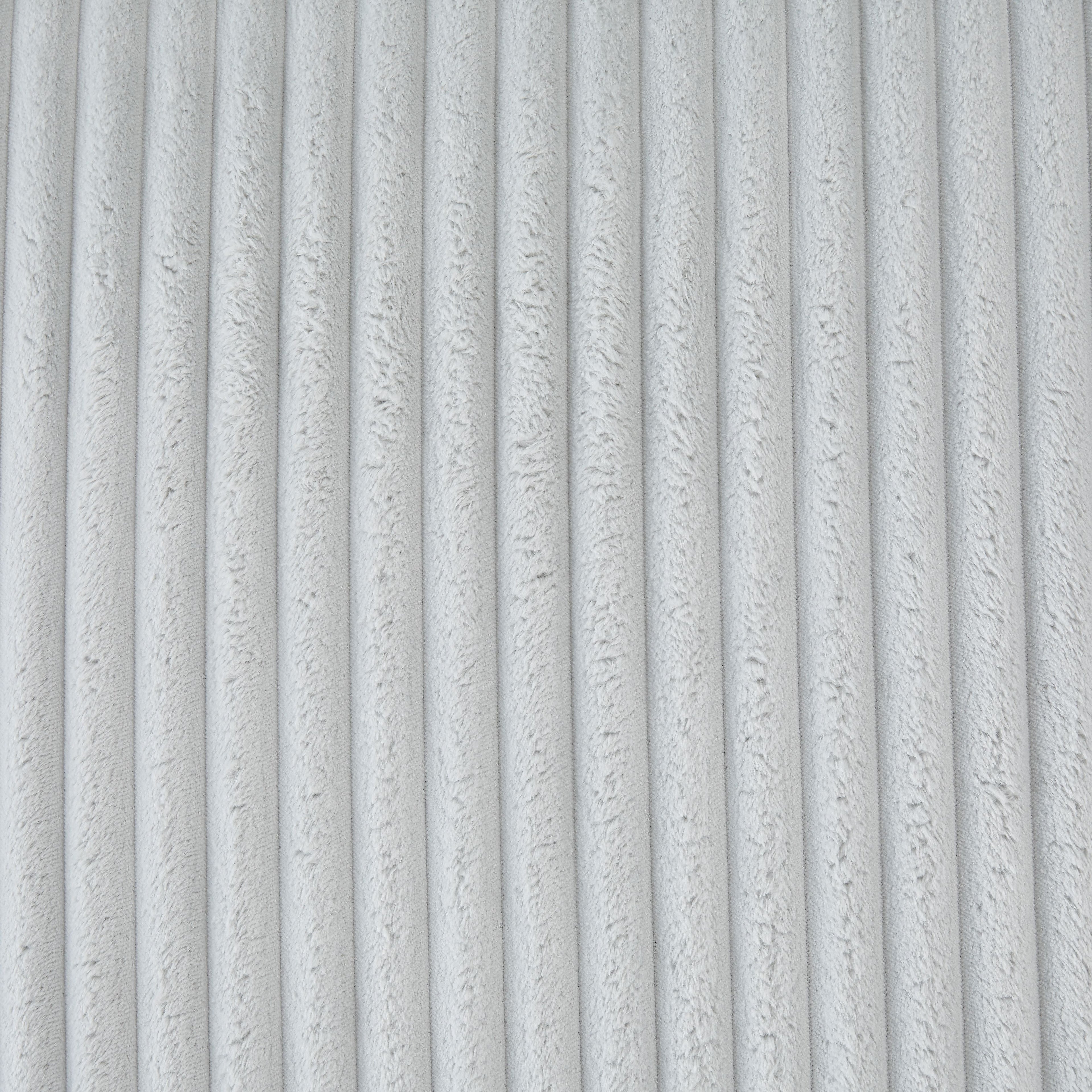 Light gray ribbed cushion fabric close-up, vertical stripe texture