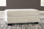 Light beige ottoman with rectangular cushion and dark tapered legs