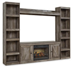 Gray entertainment center with open shelves, side cabinets, and faux fireplace TV insert