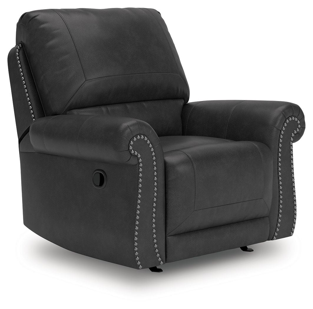 Dark gray swivel recliner with padded armrests and studded trim, side view