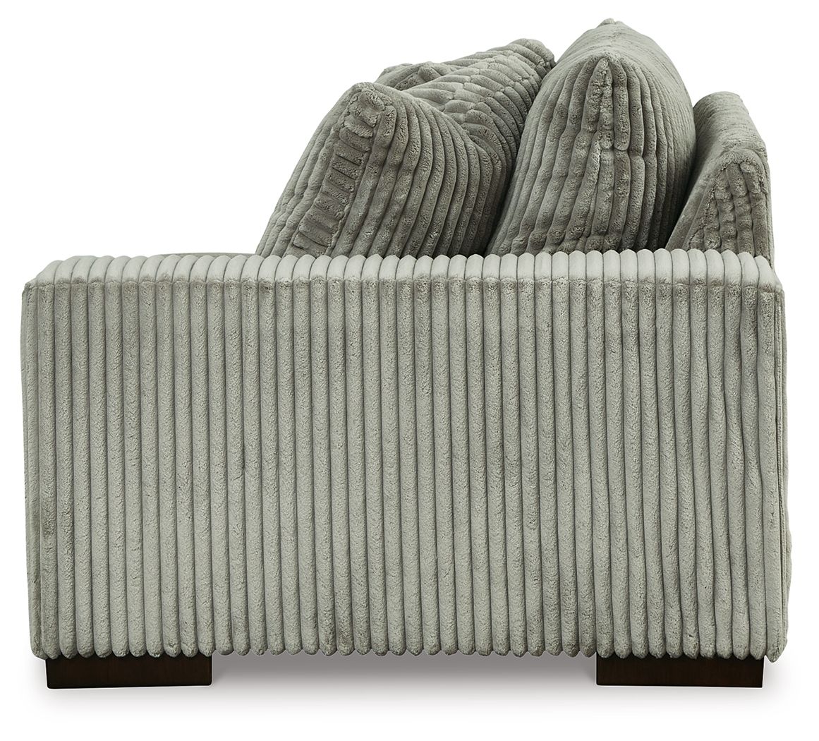 Fog corduroy corner chair with ribbed seat and back, thick bolster cushions, dark feet