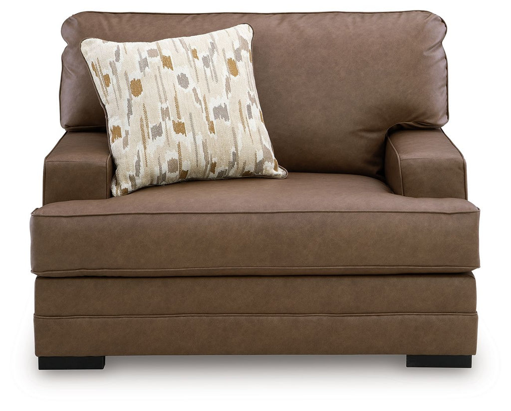 Caramel brown chair and a half with front bolster seam and patterned accent pillow