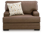 Caramel brown chair and a half with front bolster seam and patterned accent pillow