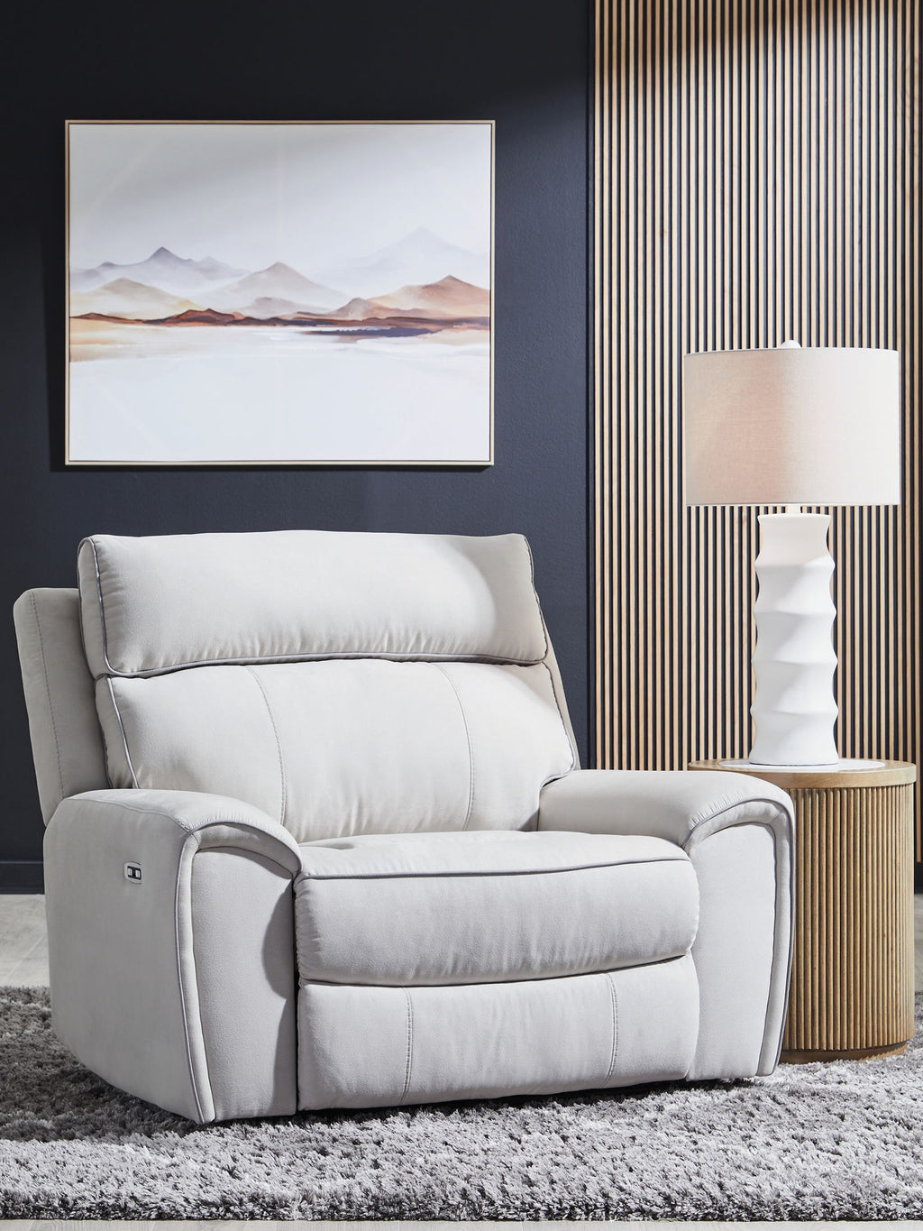 Light gray power recliner chair with tall padded back and cushioned seat