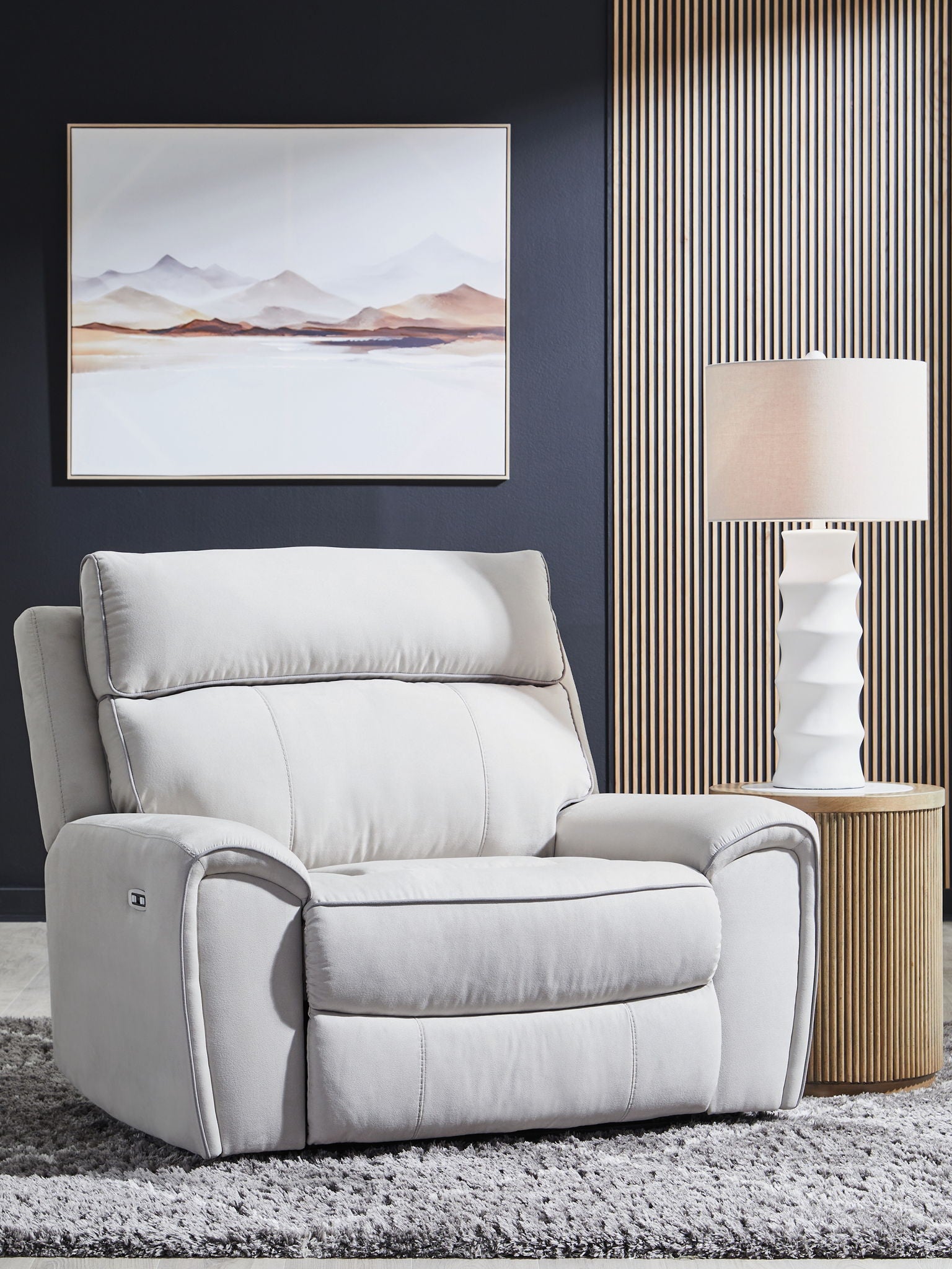 Light gray power recliner chair with tall padded back and cushioned seat