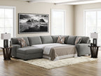 Gray sectional sleeper sofa with chaise, white bed cover, and accent throw pillows