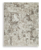 Area rug with distressed gray and beige abstract pattern, flat woven look.