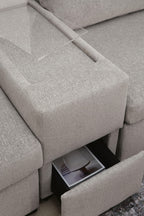 Gray sectional sofa arm area with open storage compartment beneath the seat cushion