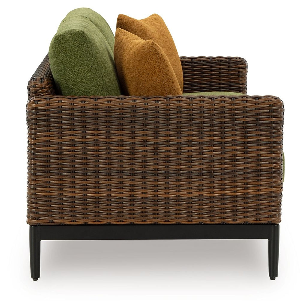 Woven brown loveseat with green and brown back cushions and armrest support
