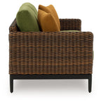 Woven brown loveseat with green and brown back cushions and armrest support