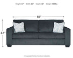 Slate sleeper sofa with two square patterned throw pillows, front profile view