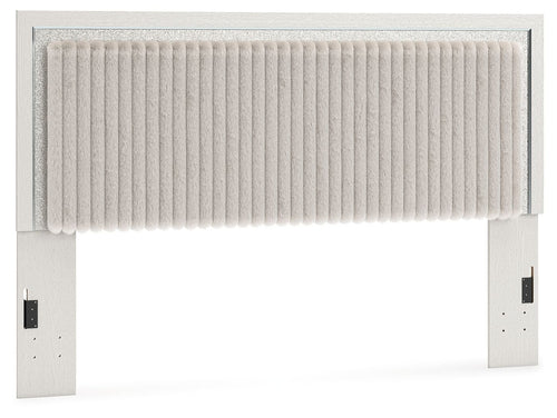 Upholstered panel headboard in light fabric with vertical channel stitching