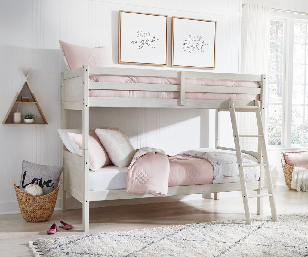 Antique white twin over twin bunk bed with ladder and pink-and-white bedding