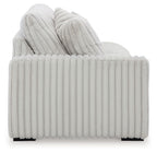 Light gray ribbed sofa back with layered cushions and thick seat bolster