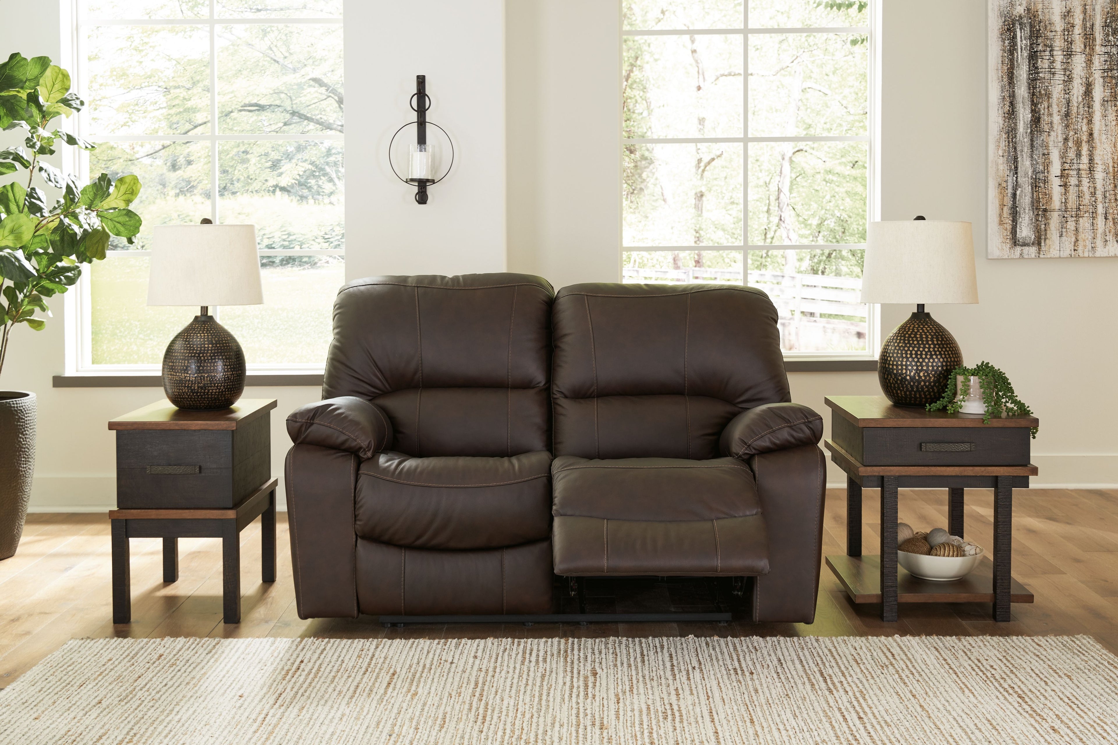 Power reclining loveseat, dark brown faux leather with padded recline and footrests
