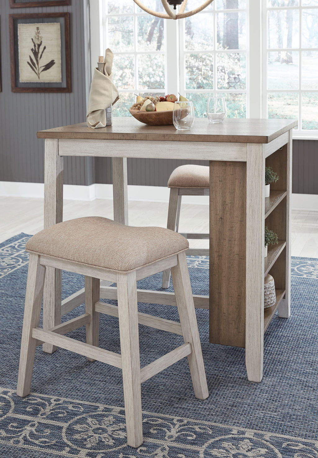 Rectangular counter table with open shelf and beige upholstered stool, side view