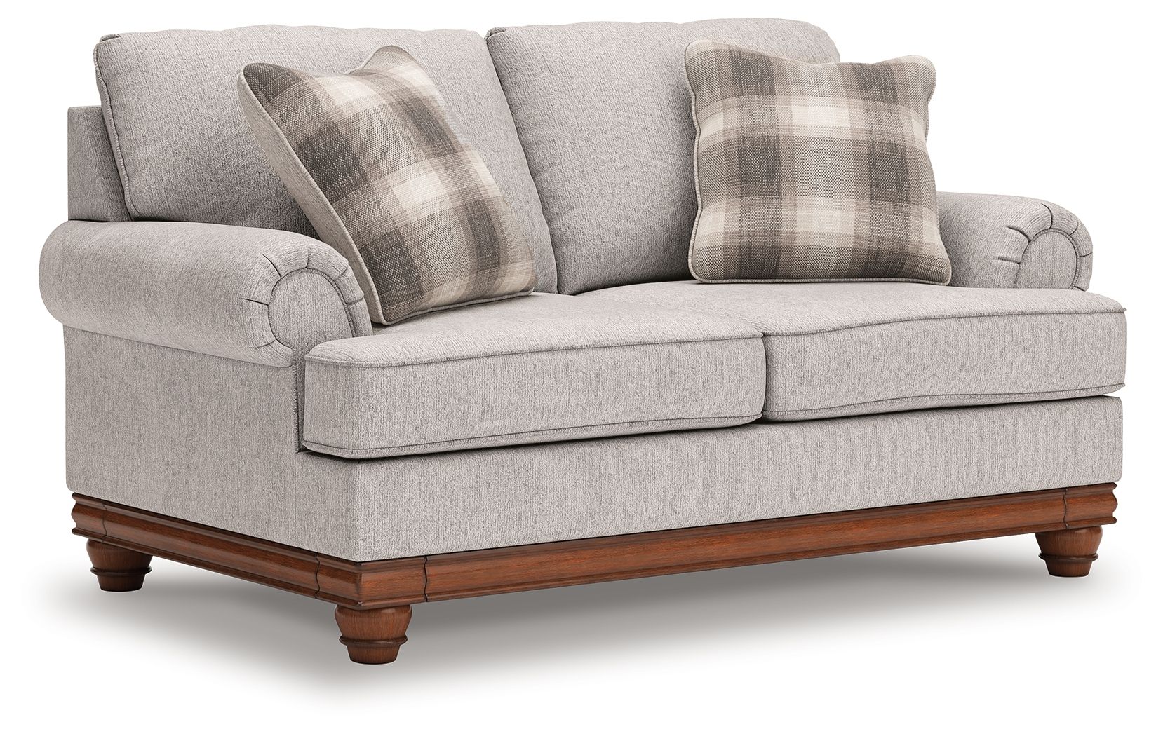 Upholstered loveseat with two front cushions, rolled arms, and plaid pillows in sand