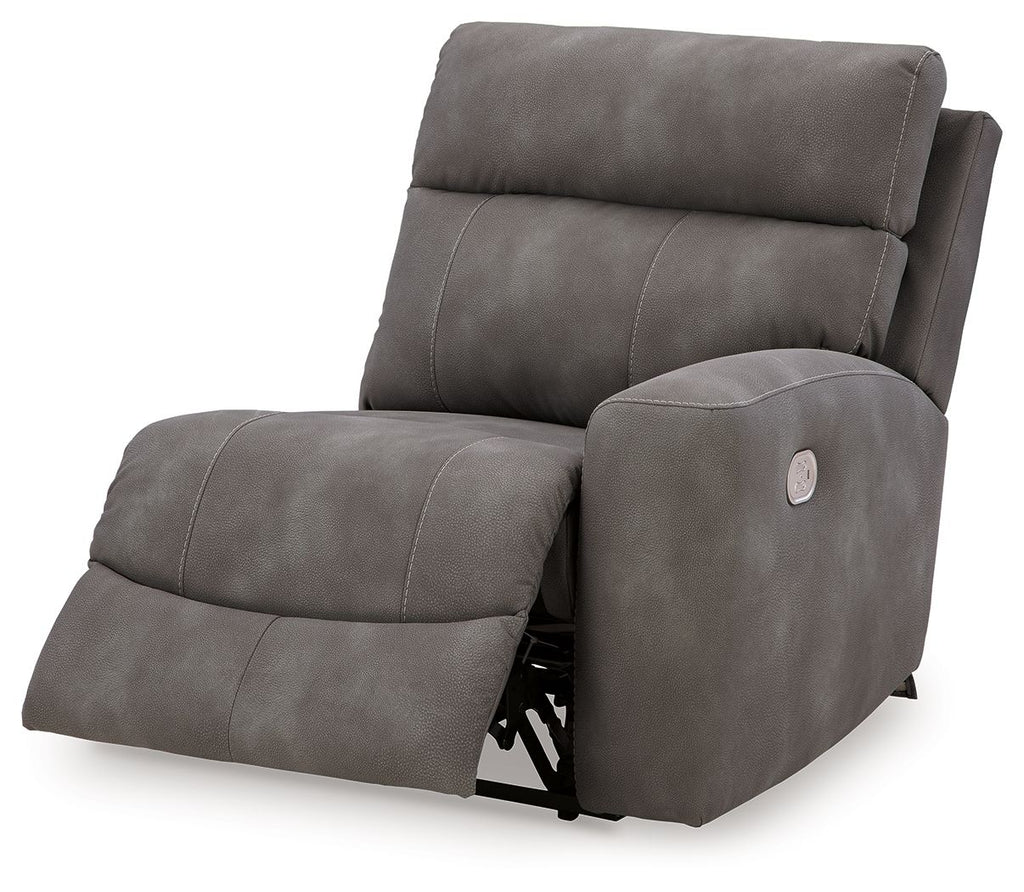 Slate gray power recliner with extended footrest and curved chaise seat, side view.