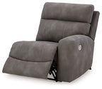 Slate gray power recliner with extended footrest and curved chaise seat, side view.