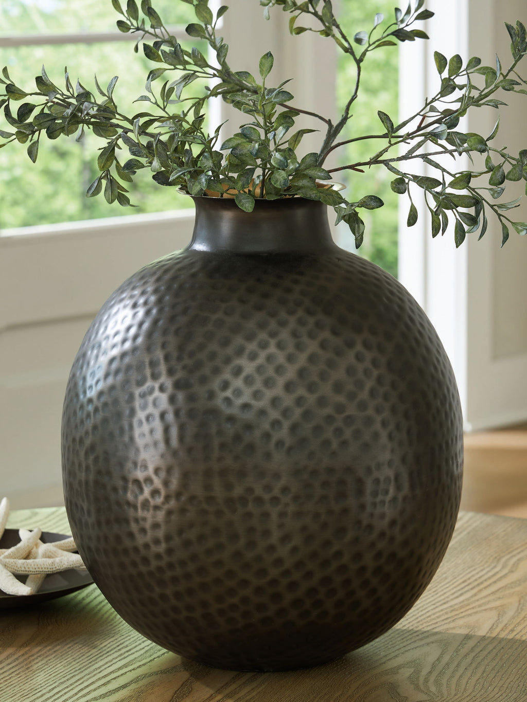 Dark gray hammered ceramic vase with gold-toned interior rim and dotted pattern
