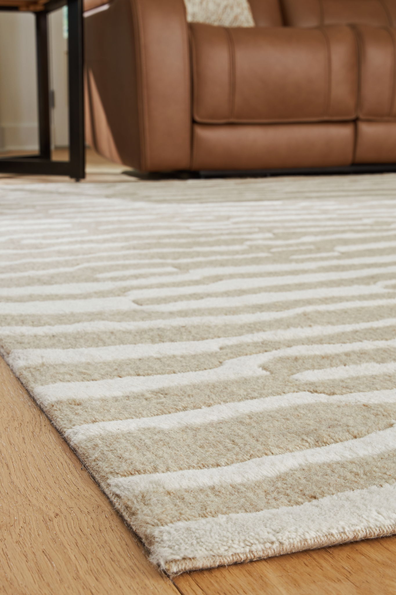 Corrbell beige rug with abstract stripe pattern and textured pile edge.