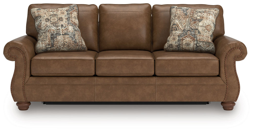 Dark brown sofa sleeper with three seat cushions and two patterned throw pillows