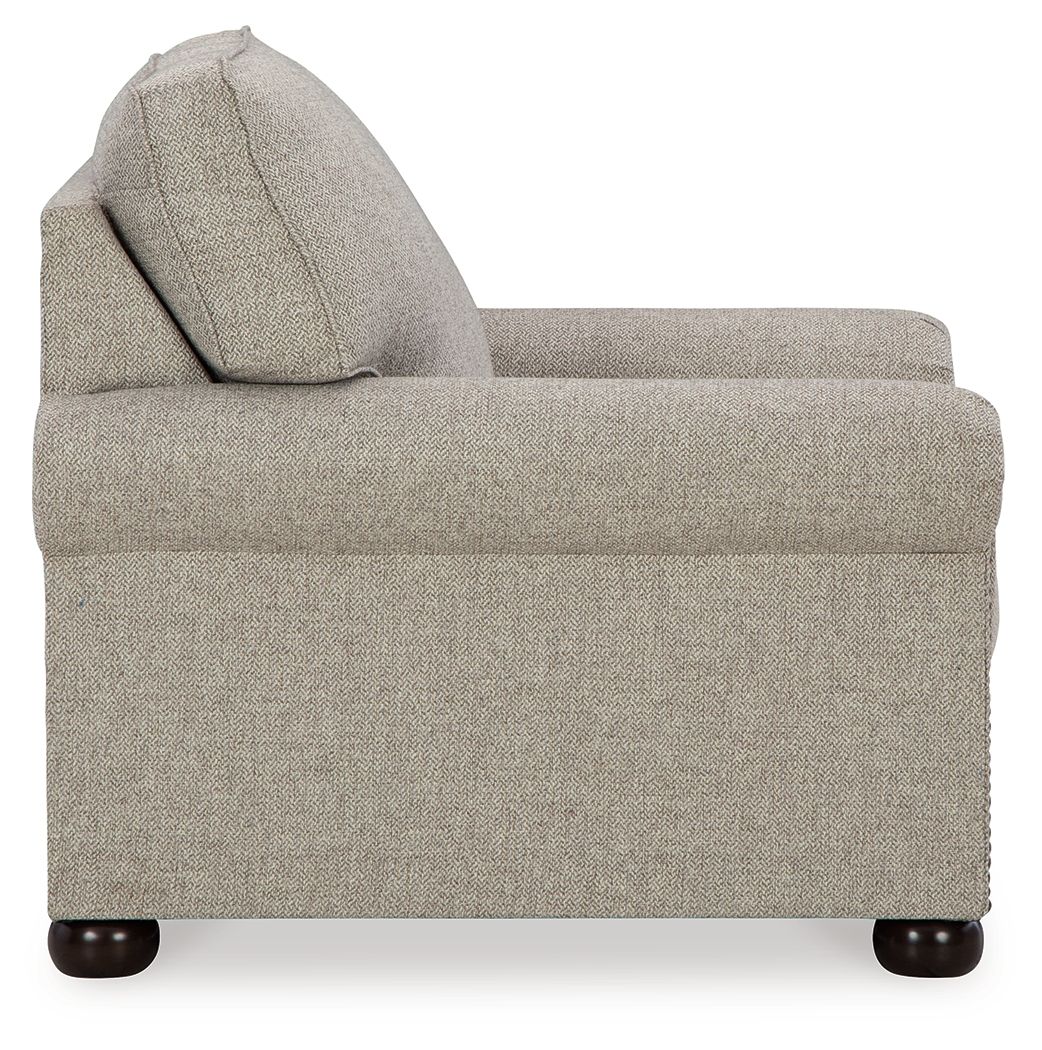 Light gray upholstered sofa section with plush seat and curved arm.