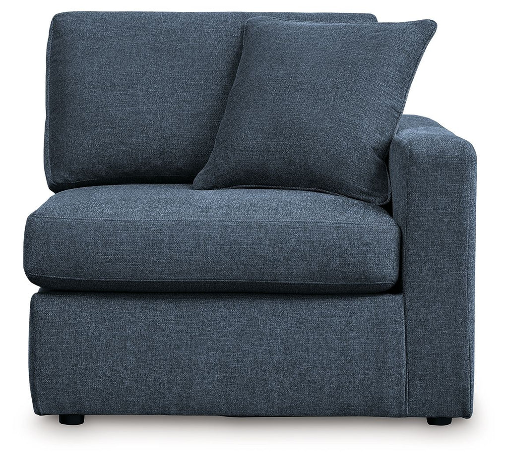 Dark navy upholstered corner chair with two large back cushions and square arms