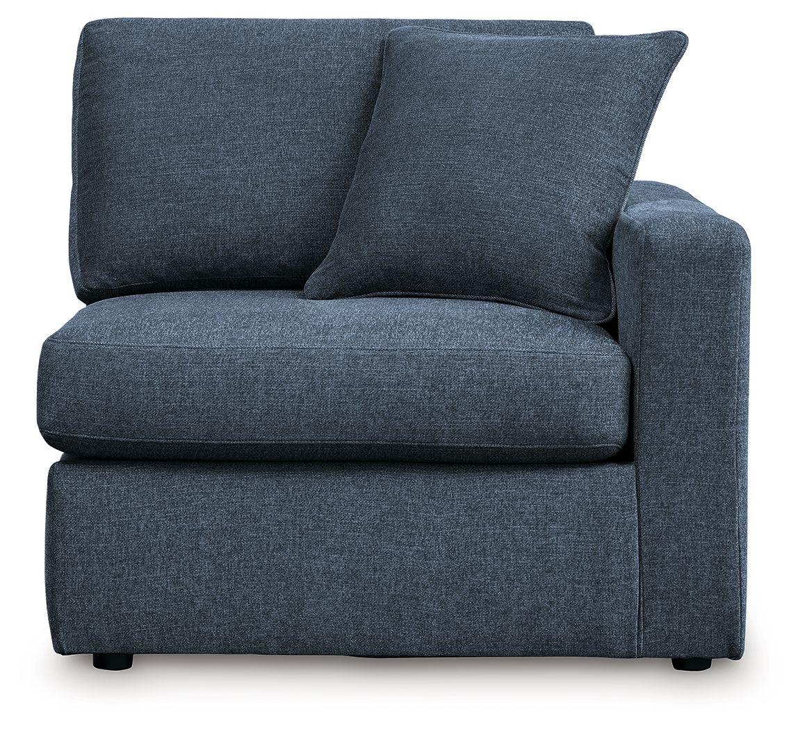 Dark navy upholstered corner chair with two large back cushions and square arms