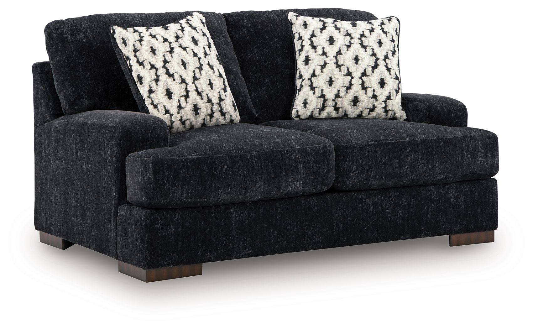 Dark charcoal loveseat with two black-and-white patterned accent pillows, thick arms