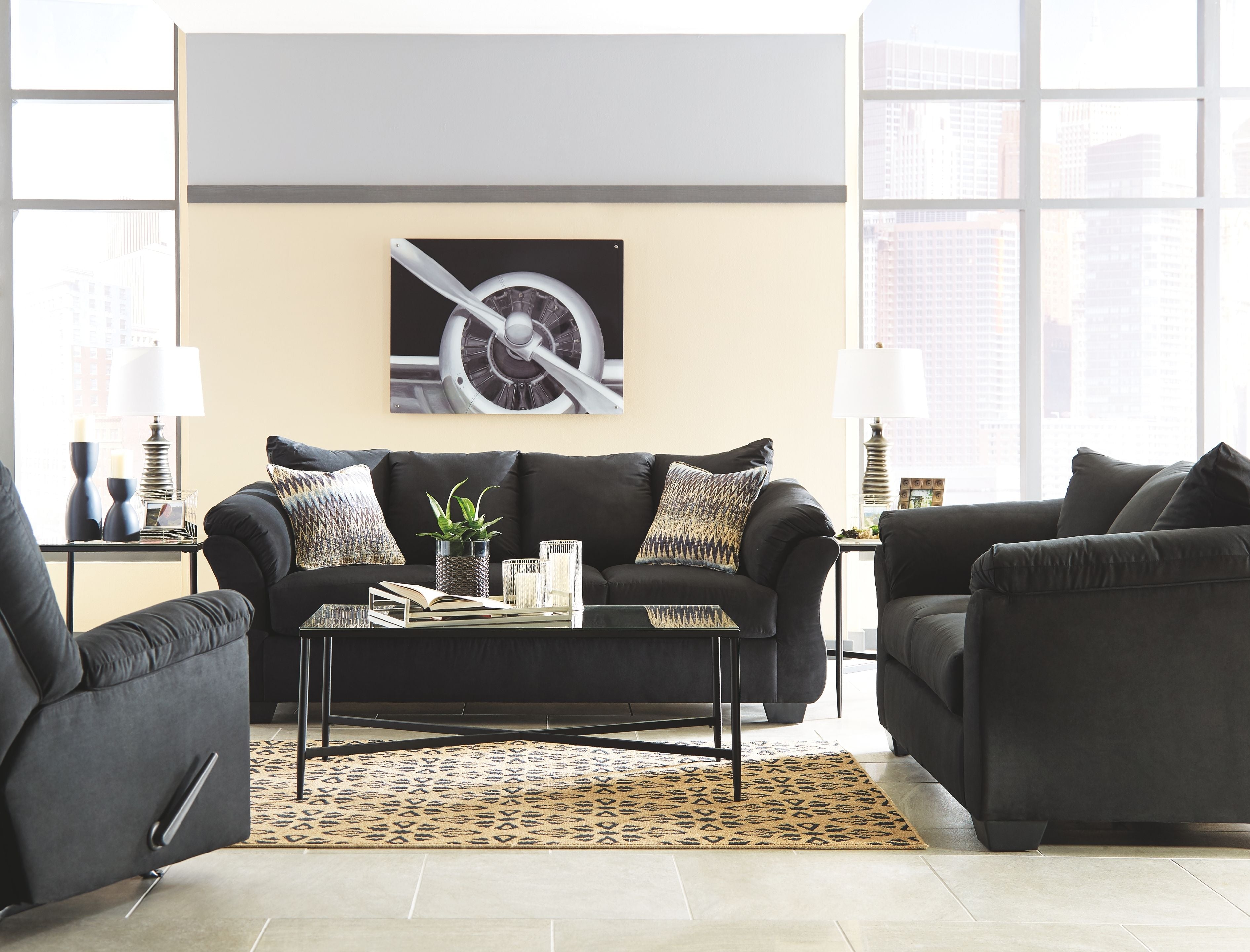 Living room set with dark sofa and loveseat, plush cushions and wide padded arms