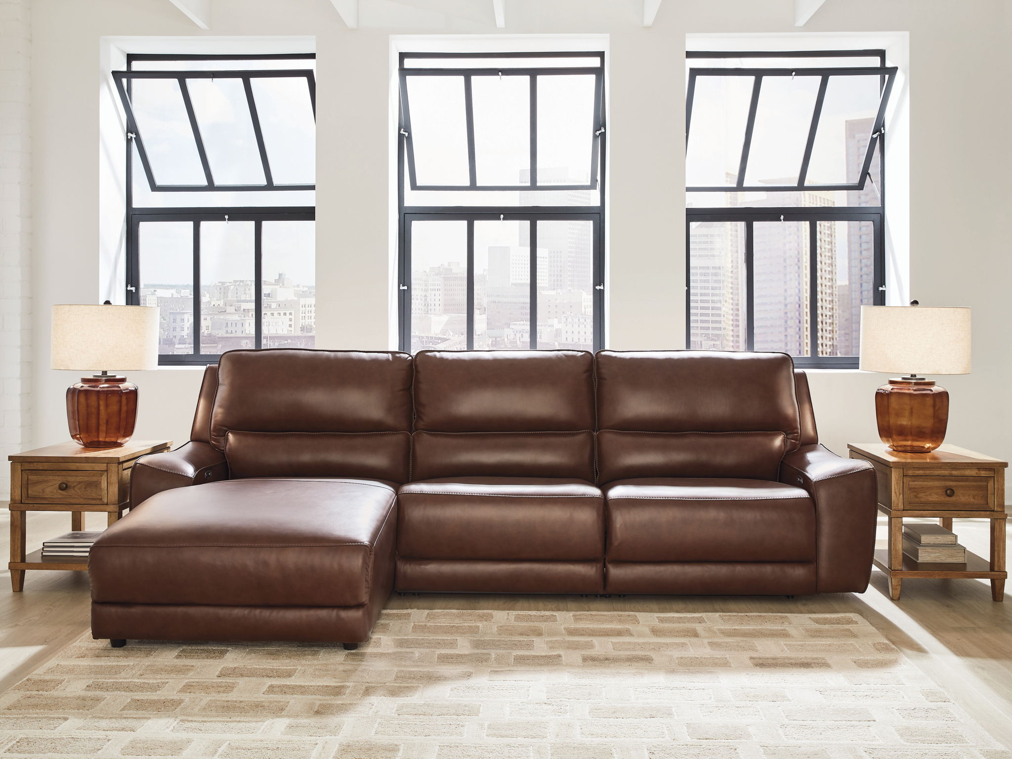 Power reclining sectional in dark brown faux leather with chaise footrest panels