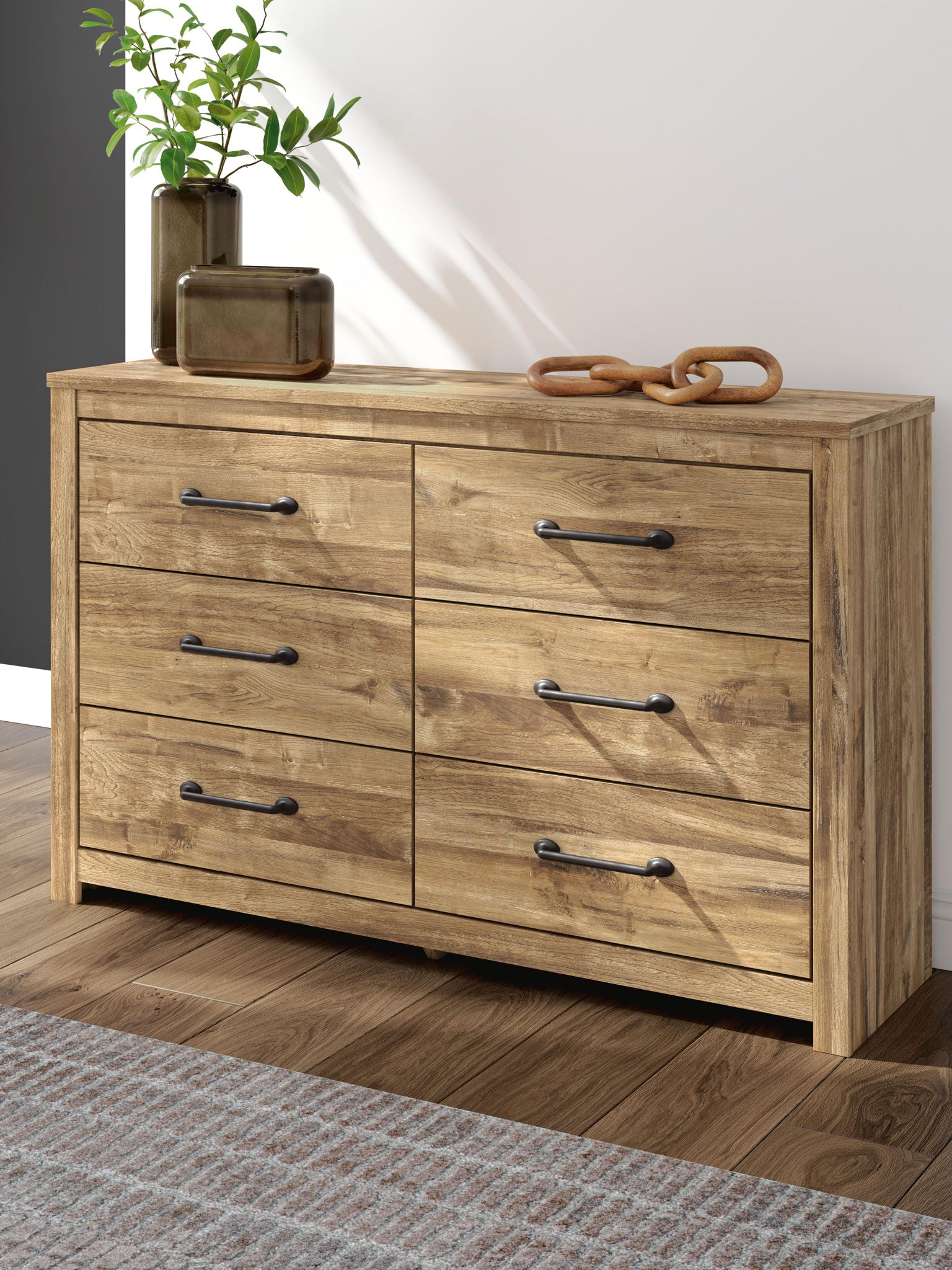 Light brown six-drawer dresser with black bar pulls and plank top.