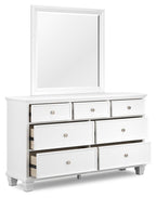 White dresser with mirror and drawer fronts, open cubbies with dark backing, metal knobs.