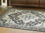 Washable area rug laid on wood floor, black-and-light blue ornate pattern.