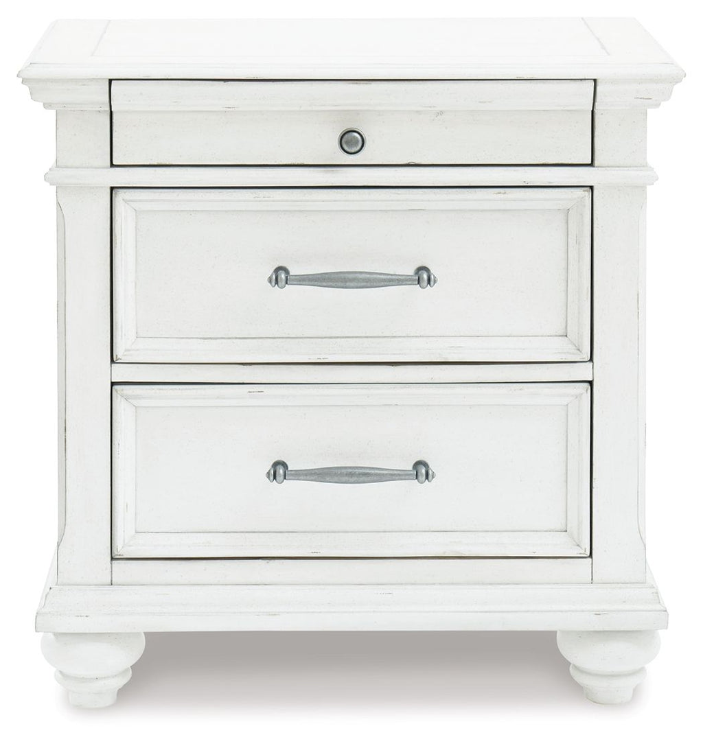 Whitewashed nightstand with two visible drawers, silver handles, and paneling