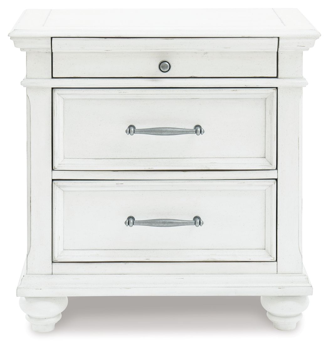 Whitewashed nightstand with two visible drawers, silver handles, and paneling