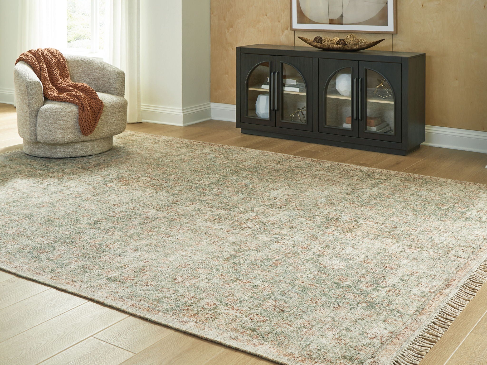 Rossbury rug, light beige ground with green and rust speckles, fringed border
