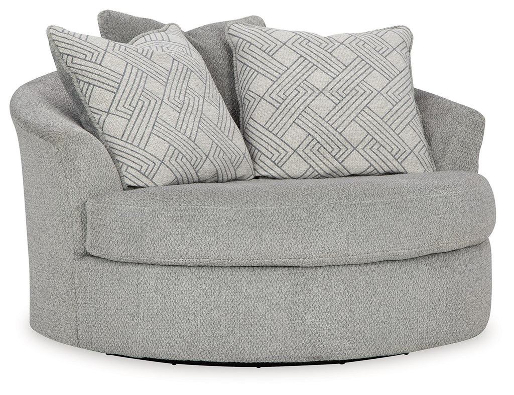 Oversized swivel accent chair in cement gray with two patterned throw pillows