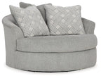 Oversized swivel accent chair in cement gray with two patterned throw pillows