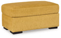 Keerwick upholstered ottoman in sunflower yellow with cushioned top and black feet