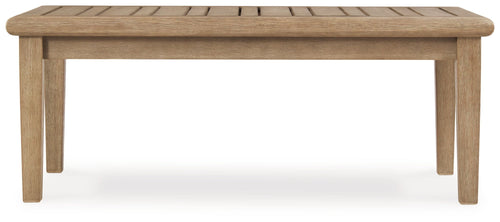 Rectangular cocktail table with beige wood top and straight four-leg base.